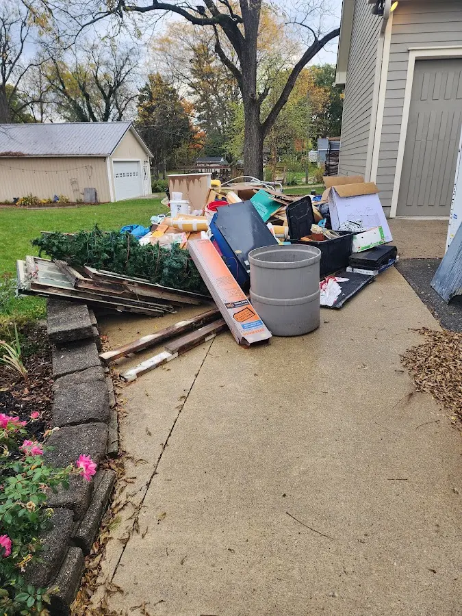 Dumpster being loaded with debris for Estate Cleanout Dumpster Rental in Orlovista